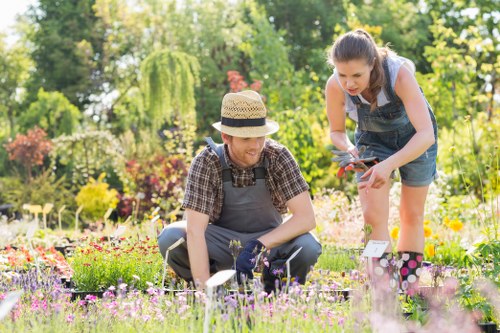 Garden crew sorting green waste into labelled containers